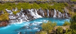 Sie besuchen den imposanten Hraunfossar Wasserfall.