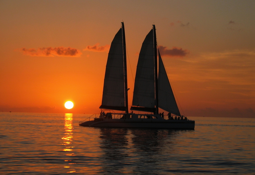 Bei der inkludierten Katamaran-Bootsfahrt beobachten Sie den Sonnenuntergang.