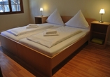 Beispiel eines Schlafbereichs in der Zimmerkategorie Blockhaus