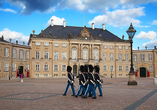 Besichtigen Sie das historische Schloss Amalienborg und vielleicht bekommen Sie die traditionelle Ablösung der Wachen mit.