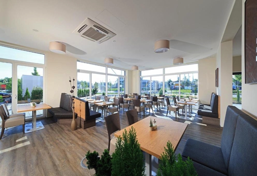 Im lichtdurchfluteten Restaurant werden Ihnen leckere Speisen und erfrischende Getränke serviert.