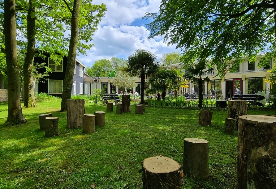 Der grüne Hotelgarten lädt zu einem Aufenthalt an der frischen Luft ein.