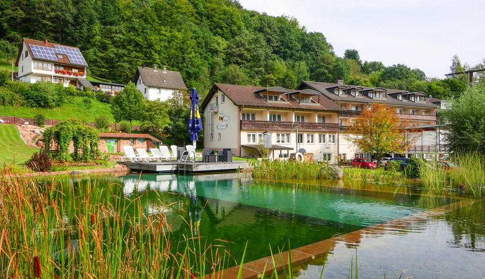 Außenansicht vom Hotel Christel mit dem großen Naturbadeteich