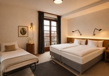 Beispielbild eines Doppelzimmers mit Zustellbett